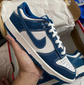Nike Dunk Low — Navy Blue / White, stitched-detail colourway